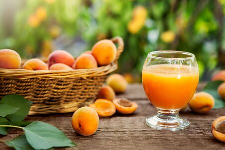 Glass of juice from apricots on the tableの写真素材