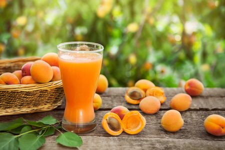 Juice from apricots in long glass for refreshmentの写真素材