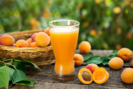Glass with apricot juice.Fresh drink from apricots on the table.の写真素材