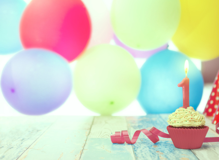 Birthday party with birthday cupcake and balloons in the backgroundの写真素材