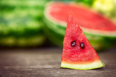 Watermelon slice on wooden tableの写真素材