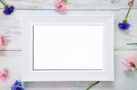 White frame mockup with fallen flowers in the backgroundの写真素材