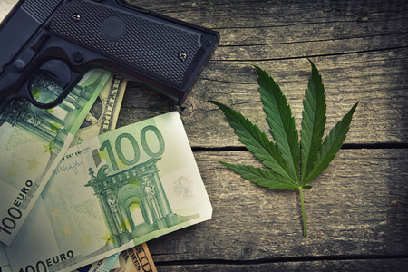 marihuana leaf on wooden table, danger businessの写真素材