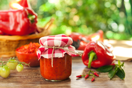 Jar with ajvar delicacy on wooden tableの写真素材