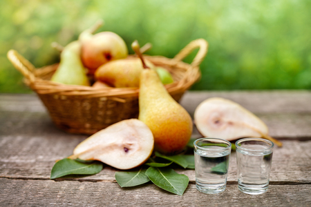 Ripe pears and pear fruit brandy alcohol drink in shot glassの写真素材
