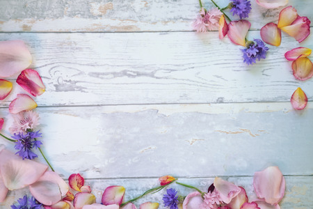 Decorative petals and fallen flowers on wooden tableの写真素材