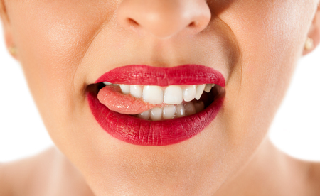 Close up of woman sexy lips biting tongueの写真素材