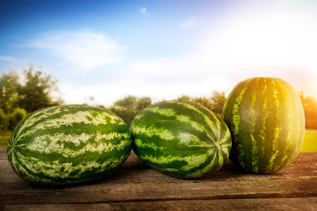 Sweet watermelons on wooden tableの写真素材