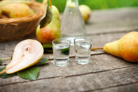 Pear alcohol drink in two shot glass with fresh pearsの写真素材
