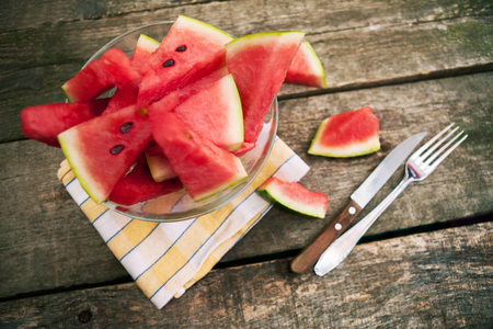Watermelon cuts in bowl and cutlery on the side.Top view.の写真素材