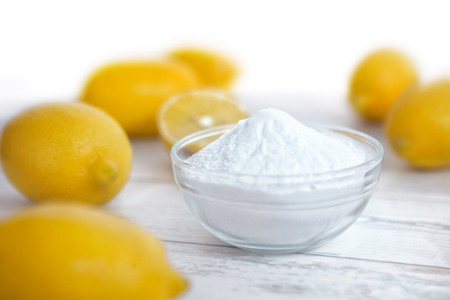 Organic cleaners, lemon and baking soda on wooden surfaceの写真素材