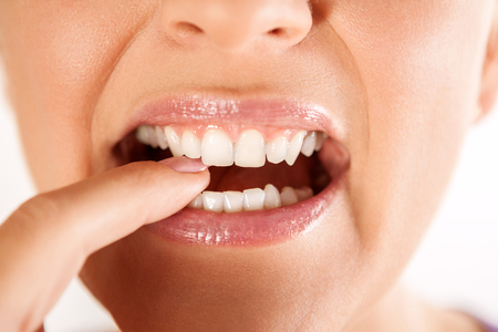sexy natural lips with white teeth biting finger の写真素材
