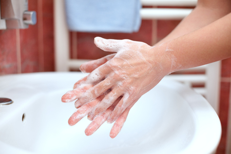 Hand cleaning in bathroom. Soapy hands. Hand washing.の写真素材