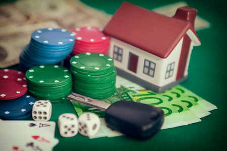 Card chips with house and car keys, house, money, cards and cubesの写真素材