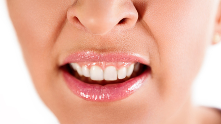 Close up of female angry mouth with white teeth の写真素材
