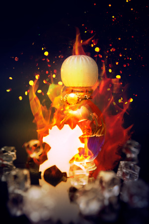 Love potion in small bottle with burning fire flame and crystals around the bottleの写真素材