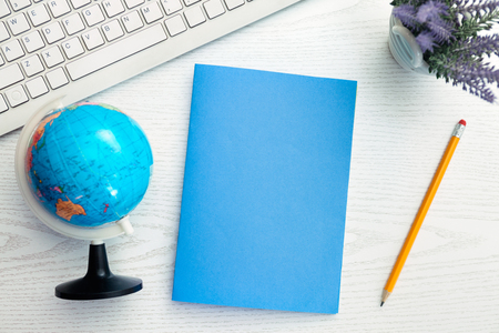 Empty blue paper on white office deskの写真素材