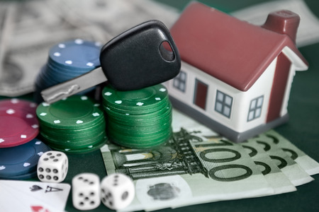 Card chips with car keys, house, money, cards and cubesの写真素材