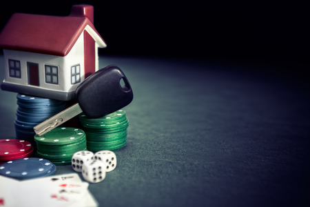 Poker table with poker chips, cards , plastic house and car keysの写真素材
