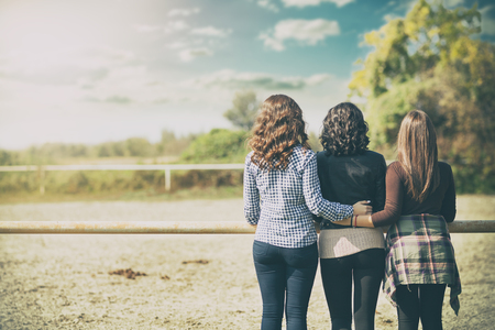 Back view image of young three ladies standing over beauty nature  backgroundの写真素材