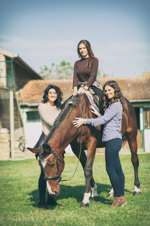 Group of rider woman with horse, recreation on countrysideの写真素材