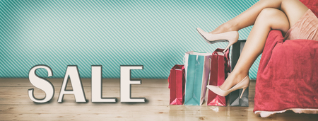 Woman legs in high heels with shopping bagsの写真素材