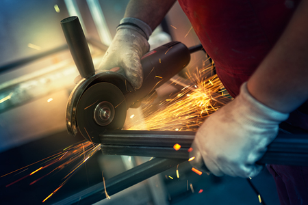 Metal cutting with angle grinder. Man cuts metalの写真素材
