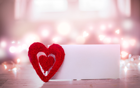 Valentine Card. Heart and empty paper card on the table. Valentines day concept.の写真素材