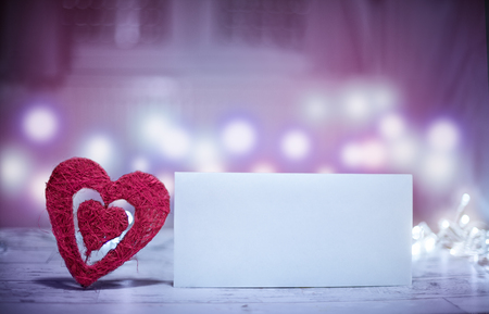 Romantic Valentines day heart and empty paper invitation. Valentines day concept with handmade heart and empty paper.の写真素材