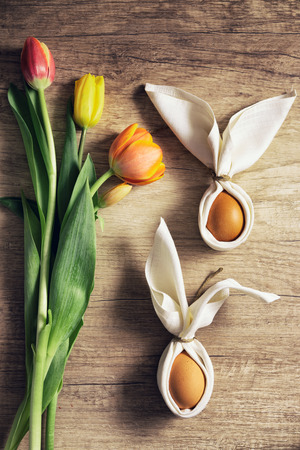Festive Easter table setting with eggs, bunny ears decoration for Easterの写真素材