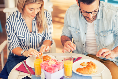 food, eating, people and healthy food concept , couple having breakfastの写真素材