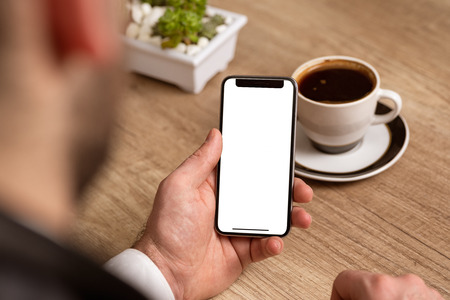 Man holding smart phone with white empty screen, for graphic display montageの写真素材