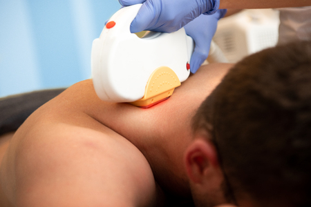 Hair removal cosmetology procedure from a therapist at cosmetic beauty spa clinicの写真素材