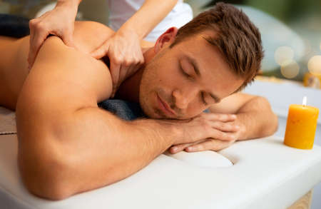 Man relaxing at wellness center enjoy in body massage treatmentの写真素材
