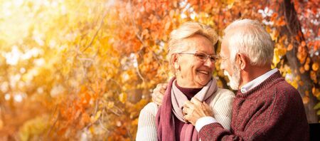Tender couple embracing on bench, smiling and enjoying romantic date, love