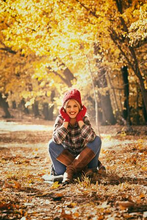 Young happy woman enjoying fresh air in autumnの写真素材