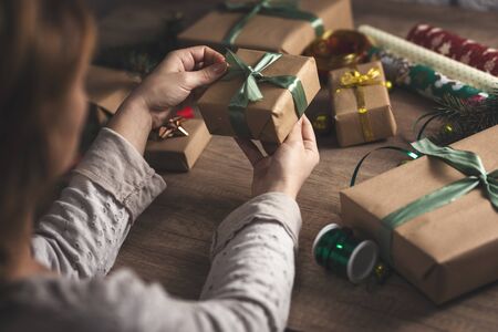 Woman warping and decorating Christmas giftの写真素材
