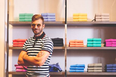 Happy man posing in in clothes from the new collection he chose for himself. Fashion, shopping, perfect lookの写真素材
