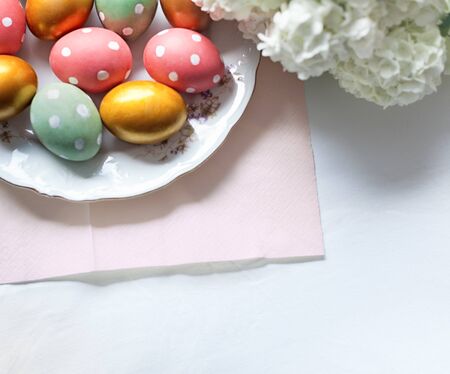 Easter table with decorated eggs and charming spring flowersの写真素材