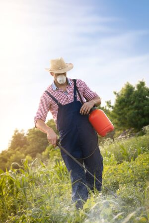 
Man farmer spraying potato plantの写真素材