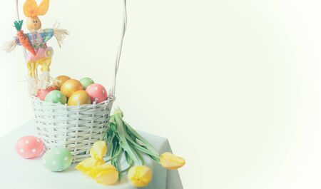 colorful Easter eggs in basket with copy space