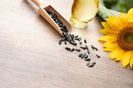 Sunflower oil in bottle glass with seed and copy space on wooden table の写真素材
