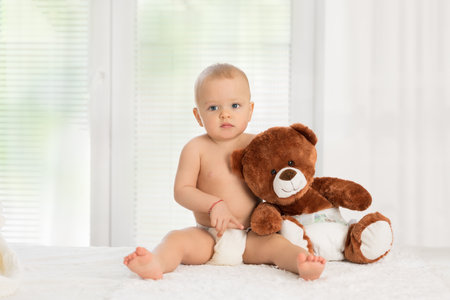 Baby girl playing with teddy bear. Concept babyhood