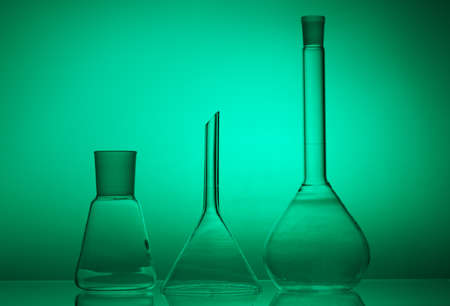 Laboratory glassware on color background on the table.