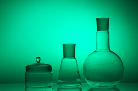 Laboratory glassware on color background on the table.の写真素材