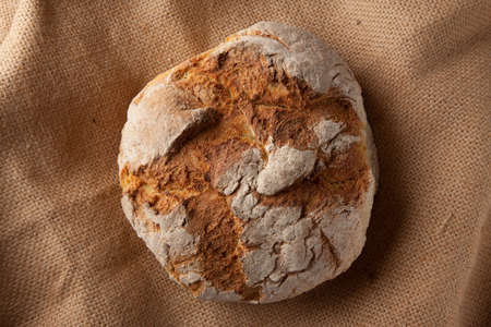 Close up view of a Portuguese traditional baked bread on brown background.