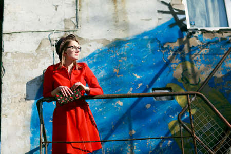 Retro style woman in red dress and black hatの写真素材