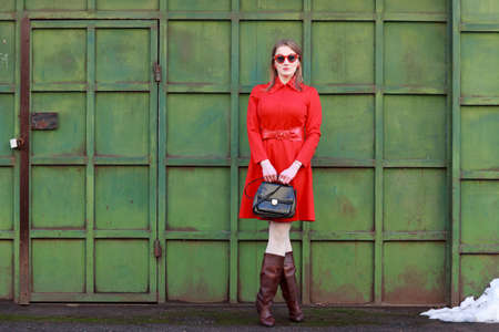 Retro style woman in red dress wearing glassesの写真素材