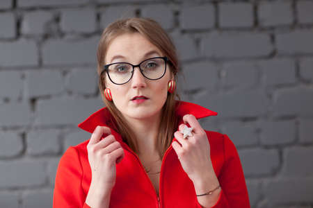 Retro style woman in red dress wearing glassesの写真素材