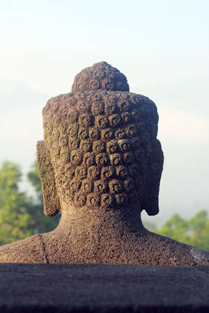 back head of a buddha statue on the top of borobudurの写真素材